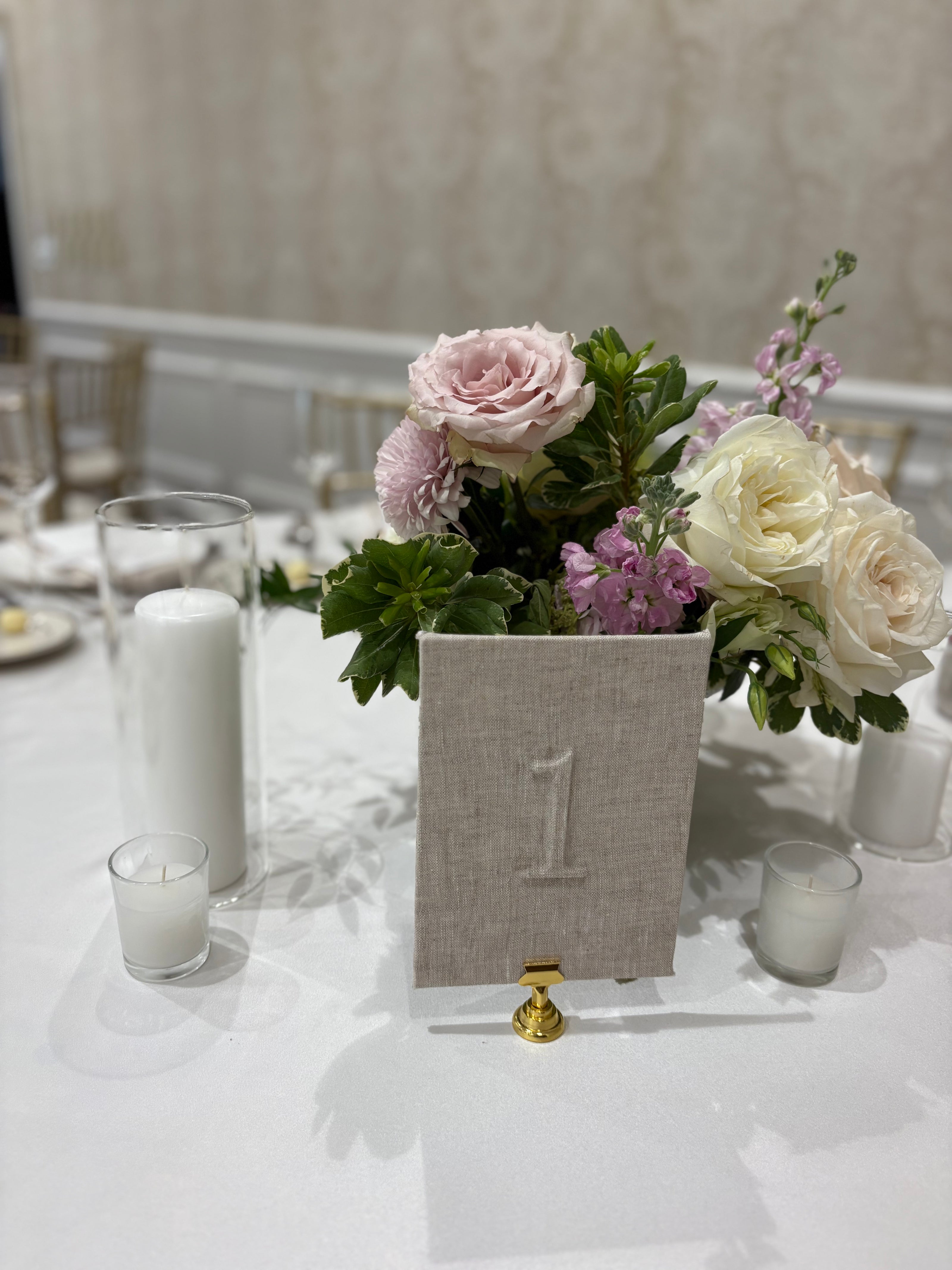 Linen Table Number Design with Floral centerpiece with pink and white flowers in a decorative box on a table with candles.