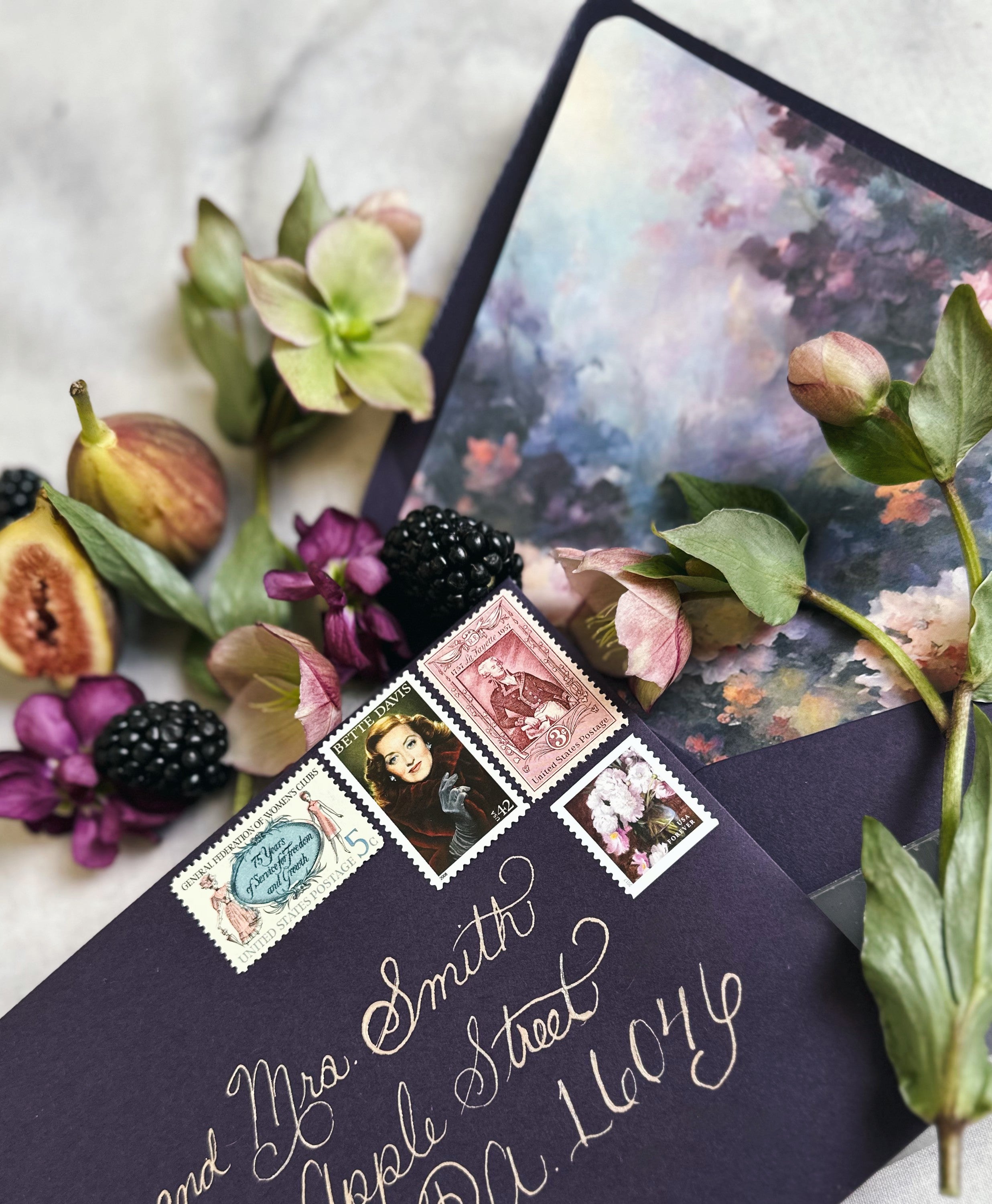 Vintage Stamps on a Decorative envelope with floral and fruit elements on a marble surface